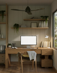 A cosy minimalist home office with a white-screen computer mockup on a wooden desk.