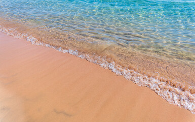 Soft wave of the sea on the sandy beach.
