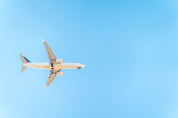 Airplane before landing in blue sky, Boeing 737-800