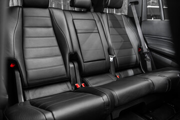 Black leather interior design, car passenger and driver seats with seats belt.
