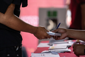 The process of a voting organizer group preparing or providing voting papers to voters in...