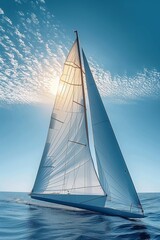 A complete view of a sailboat navigating on the sea with full sails, set against a backdrop of the sun