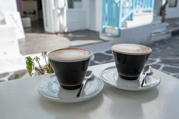 Two cups of coffee on the table, latte art