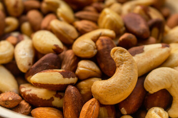 Heap of Brazil nuts, cashews and almonds in a bowl