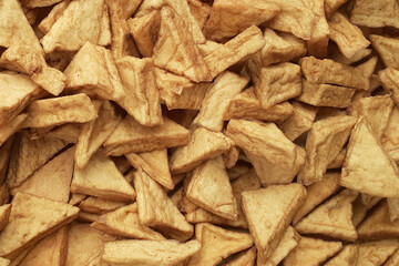 Fried tofu, a snack or cooking ingredient, ingredients from fried tofu, come in triangular and rectangular shapes