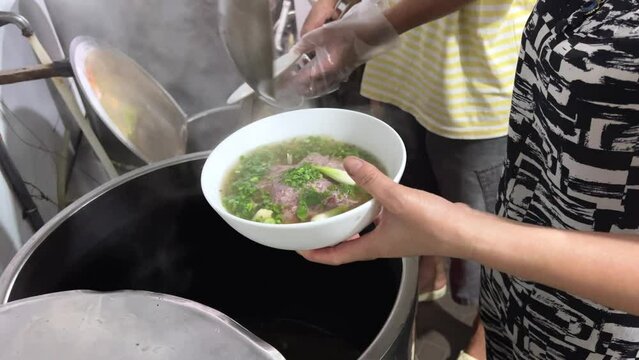 PHO BO Vietnamese Beef Noodle Soup. making soup street food in vietnam High quality 4k footage