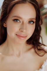 Fototapeta premium Portrait of beautiful naturally brunette woman, smiling and looking confident in camera. Close-up portrait of cute female girl isolated on white background.