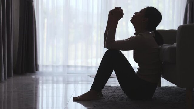 Silhouette of Woman suffering from depression lies on the sofa , has stress, anxiety, sickness and headaches, life problems, domestic violence, mental health, thoughts of suicide.