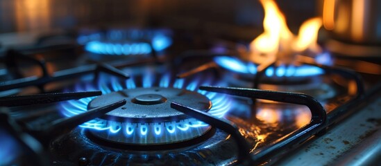 A closeup shot of a gas stove with flames roaring out of it, creating a fiery display on the cooktop - obrazy, fototapety, plakaty
