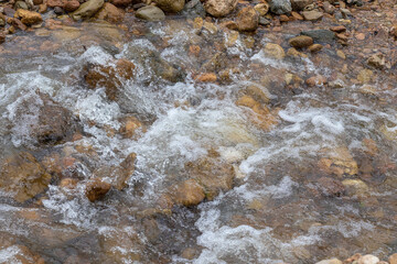 Mountain river spring season with sand and stone shoals along the banks.
