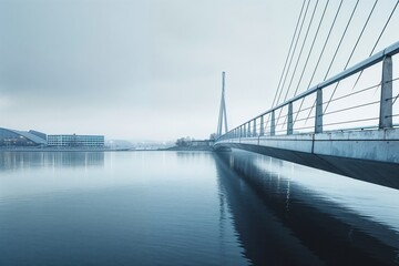 Sleek Modern Bridge Spanning Tranquil Waters on Overcast Day