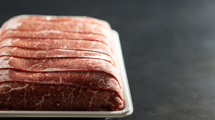 Thinly sliced frozen raw meat
