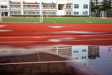 Reflection of a building on the water surface of a football field in China. used for the target...