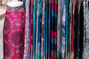 View of the traditional colored skirts displayed in the market of Luang Prabang, Laos