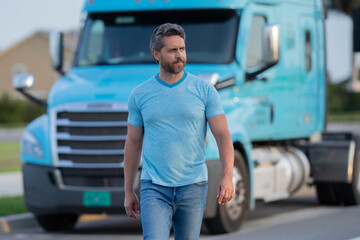 Men driver near lorry truck. Man owner truck driver. Millennial trucker. Trucking owner. Transportation industry vehicles. Handsome man posing in front of truck.