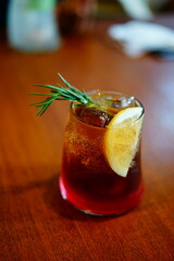A glass of ice coffee with indoor potted plant on the wooden table