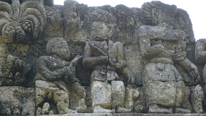 Fototapeta na wymiar Relief on the wall of Tegowangi temple in Kediri, East Java. This temple is the place for the Bhre Matahun Pendharmaan