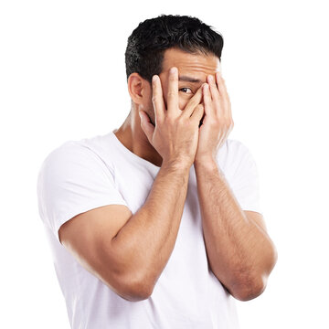 Peek, fingers and man with fear or scared, danger and caution with hands covering face isolated on png transparent background. Horror, terror and crisis, hiding from drama and terrified with shame