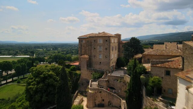 Aerial establishing shot of a chateau with gardens in Lauris, France