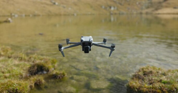 Drone Hovering Above Edge Of Lake In Italian Alps. Slow Motion Parallax Shot