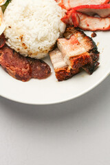 Red Pork and Crispy Pork on Rice Served with Chinese sausage, cucumber, boiled egg. and boiled bone soup, red pork and crispy pork on rice It is a popular food in Thailand.