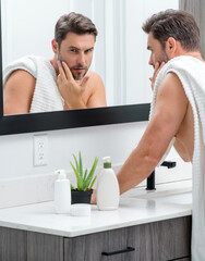Sexy sensual man with perfect skin touch face after shaving. Skin care healthcare cosmetic...