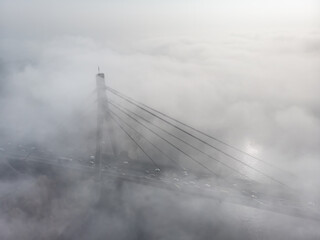 Bridge over the river at sunrise in the fog - 736831030
