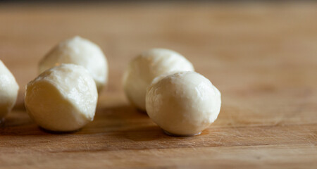 mozzarella balls close-up on wooden board