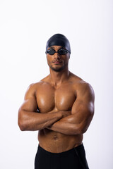 Confident young biracial male swimmer poses in swim gear