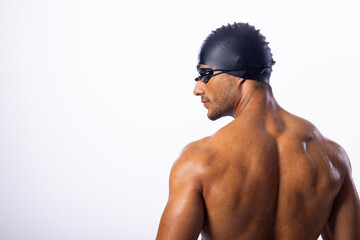 Young biracial male swimmer wearing swimming goggles