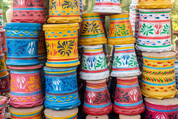 Fototapeta na wymiar Colorful painted plant pots at a garden center display for sale.