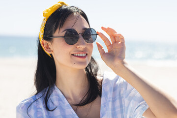Fototapeta premium Young biracial woman enjoys a sunny beach day unaltered