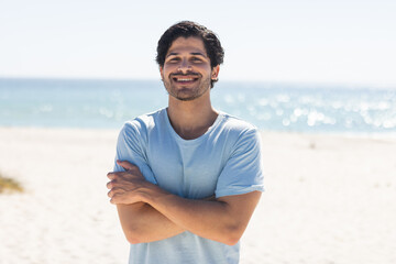 Obraz premium Young biracial man smiles at the beach