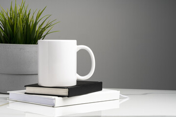 Ceramic mug on marble table on gray background