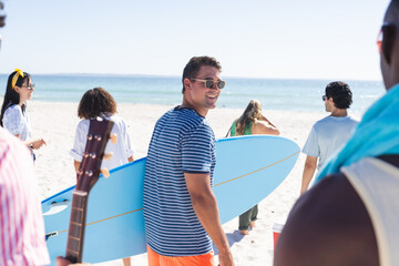 A diverse group of friends enjoys a sunny day at the beach