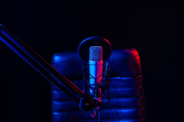 Home studio podcast interior. Microphone, table and chair