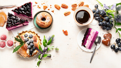 Fototapeta na wymiar Holiday cake with cup of coffee and grape on light wooden background