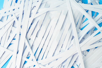 Shredded paper pieces on a blue background