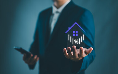 Real estate investment concept. Person holding house and up arrow icon on virtual screen for analyzing mortgage loan home and insurance real property mortgage. interest rate, Investment planning.. - obrazy, fototapety, plakaty