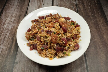 Stirred rice with Chinese pork sausage, egg and spring onion serving on the plate. Famous rice menu in Asian restaurant. Classic breakfast menu concept.