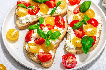 Fresh bread sandwiches with tomato cherry, cream cheese and basil leaves. Morning breakfast concept