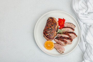 Fried duck breast with fresh orange and ginger, ready to eat food. Domestic cuisine, poultry meat