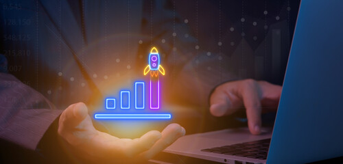 Businessman showing neon illustration rocket take of with growth up neon bar graph chart. The...