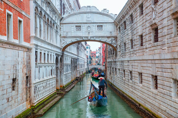 Gondolas floating on canal towards Bridge of Sighs (Ponte dei Sospiri). Venice, Italy