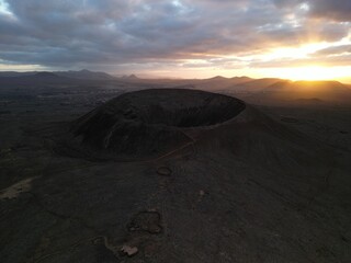 Calderon Hondo volcano from above at sunset near Lajares, Canary Islands, Fuerteventura. Amazing sunset overlooking the extinct Hondo Volcano and Bayuyo Volcano. Volcanic mountains in Fuerteventura © Andrzej