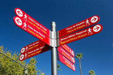 Signpost in Seville directing visitors to various sights in the city of Seville, Spain