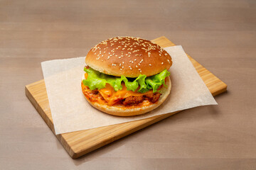Sandwich with pork and cheese. On a wooden board.
