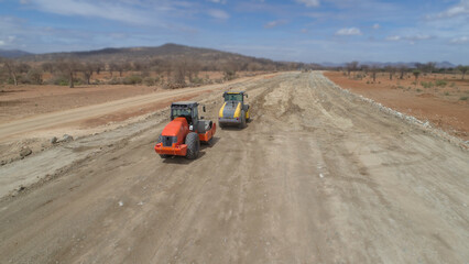 construction machines at works, dozer, roller machine, excavator, crawler rock drill machine, trucks, GPS grader