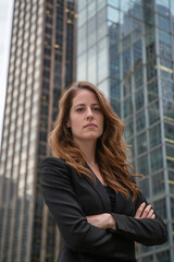Fototapeta premium A business owner stands with his arms crossed in front of a tall building in the city. Ai generate.