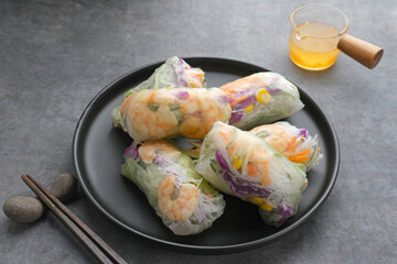 Vegetable spring roll, fresh roll salad made from mix vegetables with shrimp. Served in plate with caesar sauce dressing
